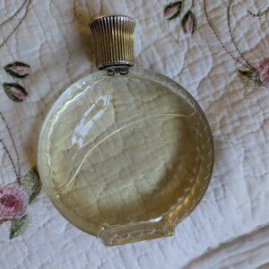 Vintage Lalique bottle with contents unmarked. Round with  design on edges.
